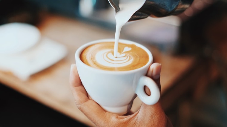 A latte poured with a rosette of latte art